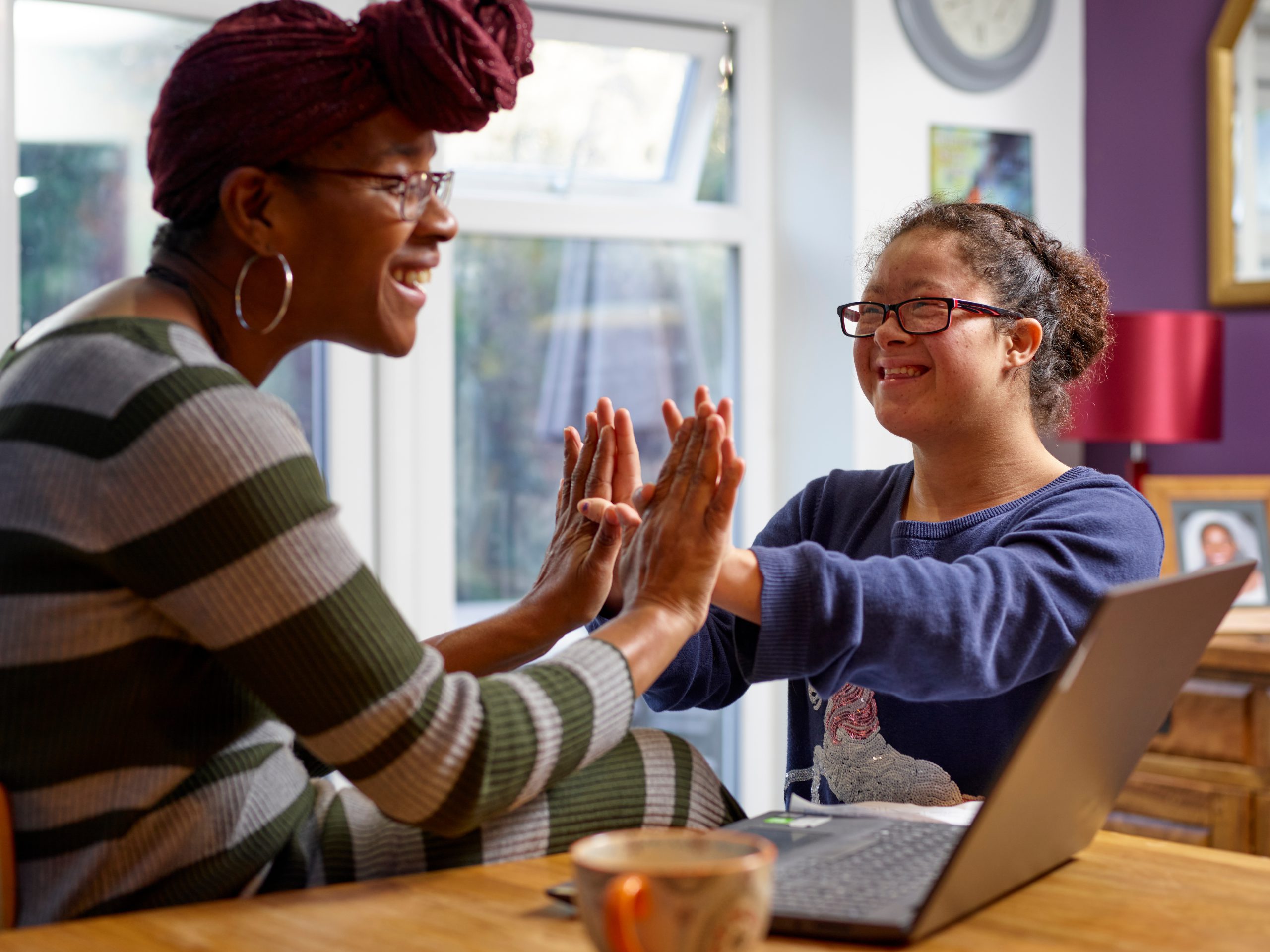 Mother with daughter with Down Syndrome playing at home